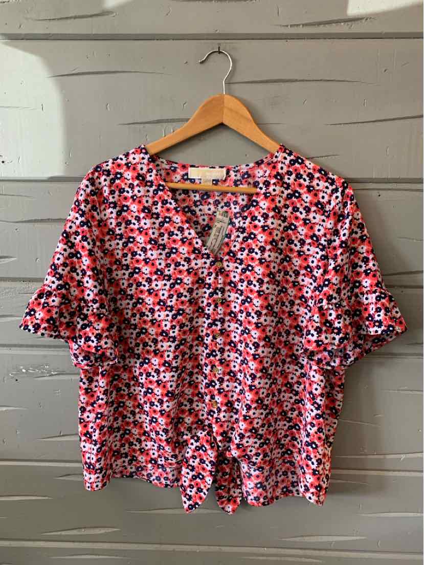 Pink floral short-sleeve blouse with V-neck and relaxed XL fit on wooden hanger.