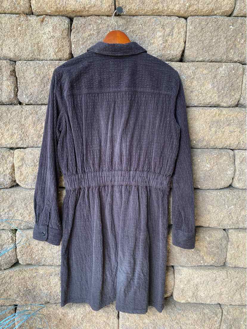 Black long-sleeve dress with button-up front and cinched waist, made from textured fabric.