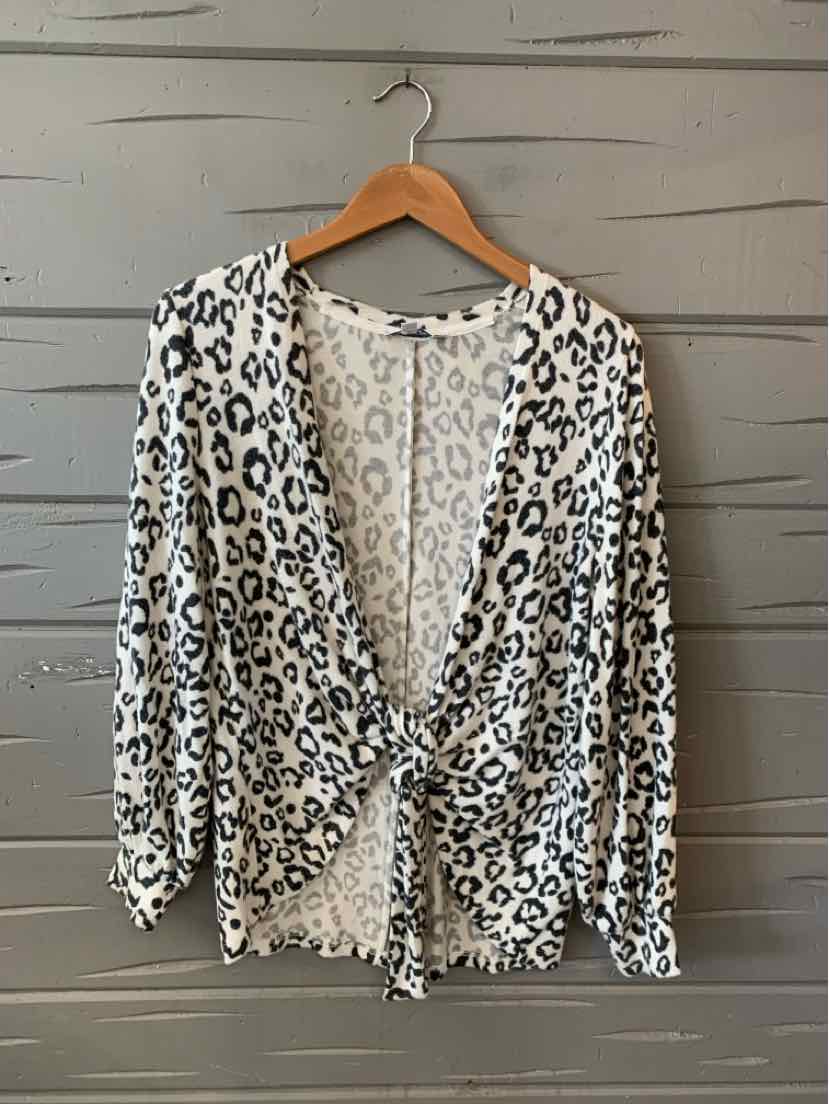 White leopard print lightweight blouse with long sleeves and front tie detail.