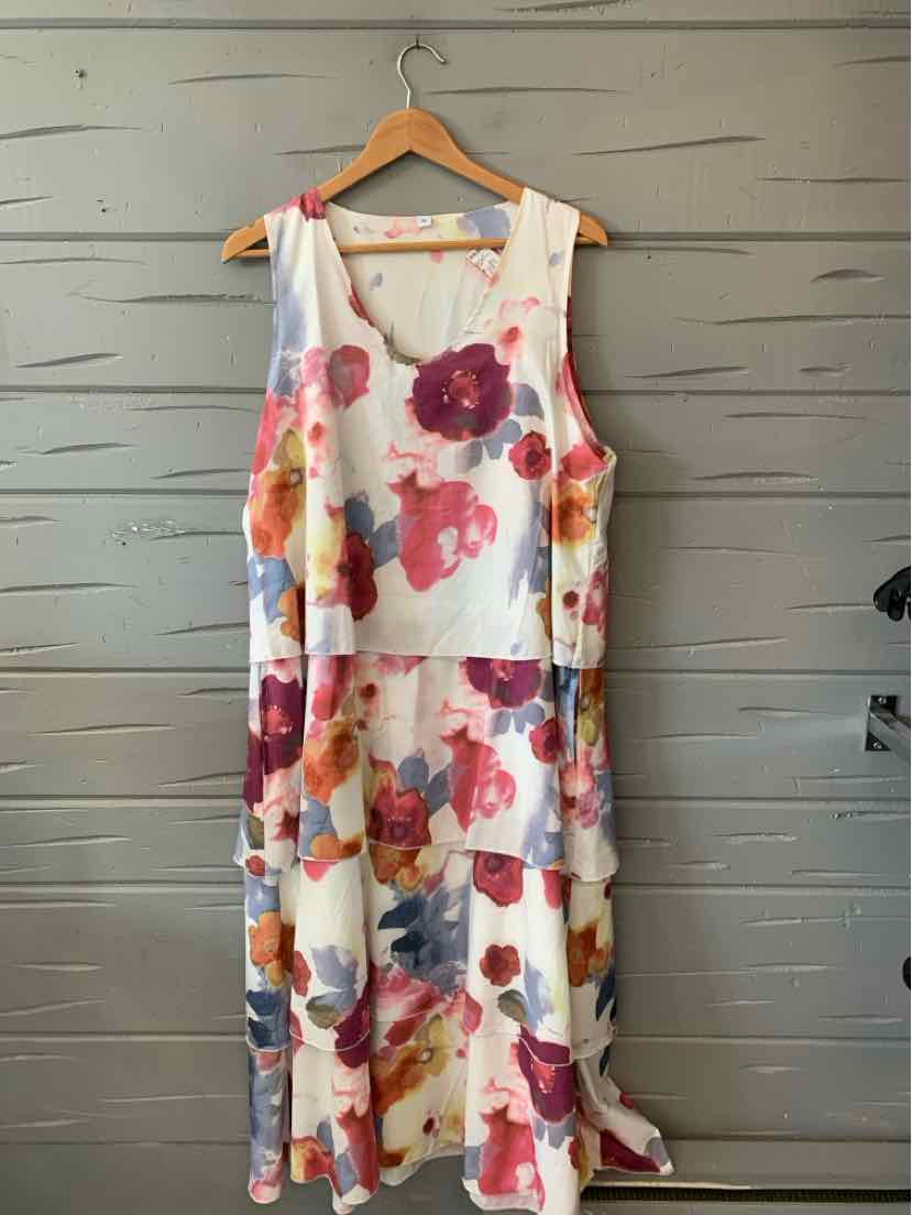 Sleeveless white dress with bright pink, red, and purple floral print, loose fit, knee-length.