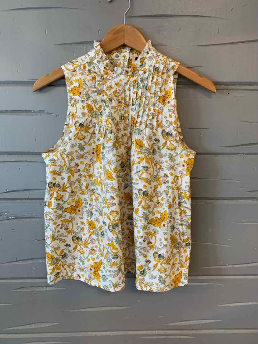 Sleeveless white blouse with yellow floral print and button-up front in XS size.