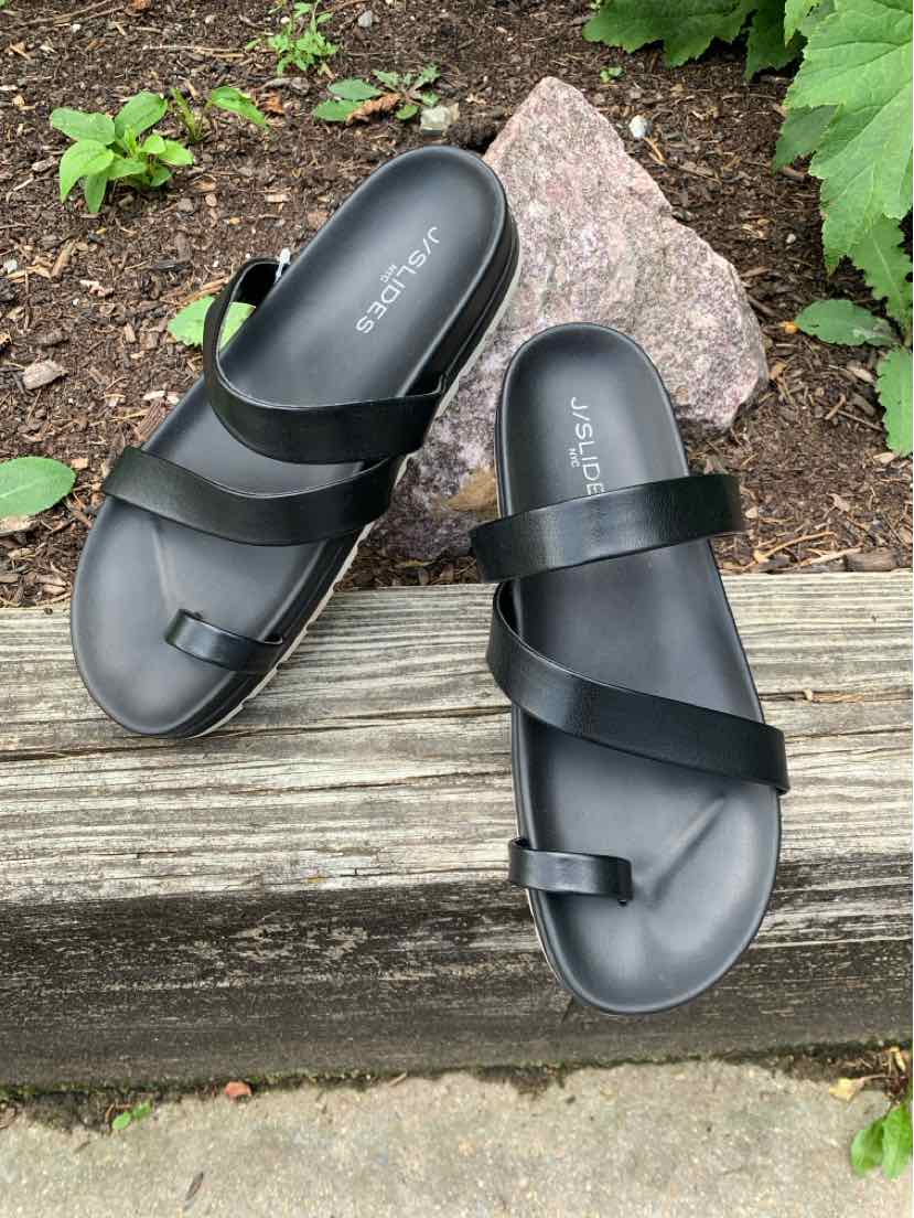 Black slide sandals with two wide crisscross straps and a toe loop, size 9, matte finish.
