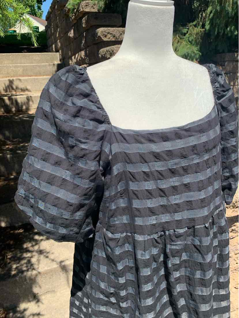 Black and gray striped dress with puff sleeves and square neckline on white mannequin.