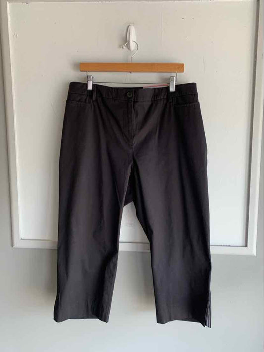 Black wide-leg pants in size 14W with front pockets and belt loops hanging on wooden hanger.