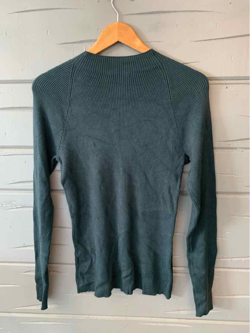 Dark green long-sleeve fitted knit sweater with crew neckline on wooden hanger.