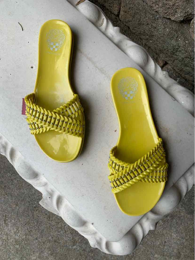 Yellow slide sandals with braided straps and a flat sole in size 8.