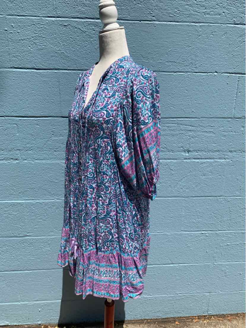 Blue and pink floral patterned midi dress with 3/4 puff sleeves and V-neckline on mannequin.