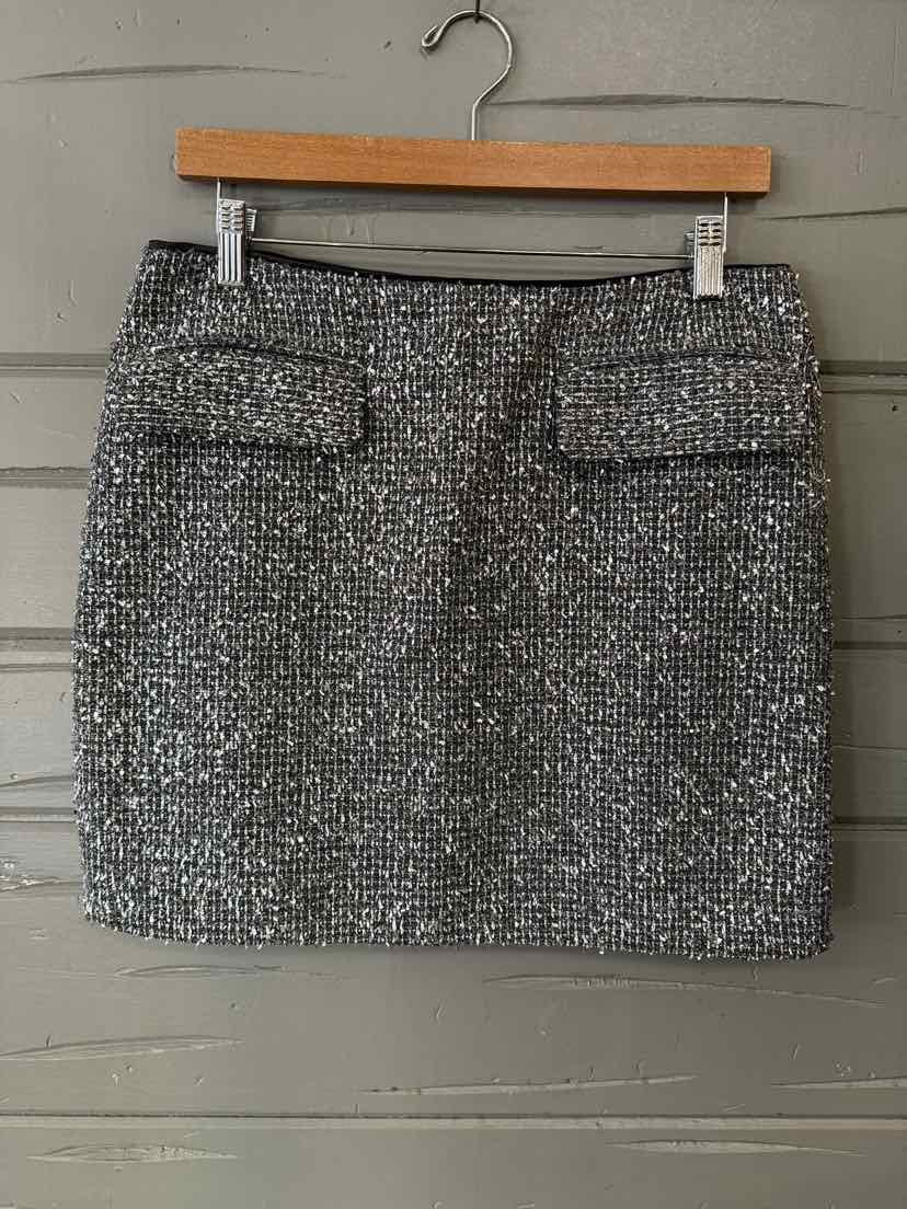 Metallic silver tweed mini skirt with front flap pockets, size 6.