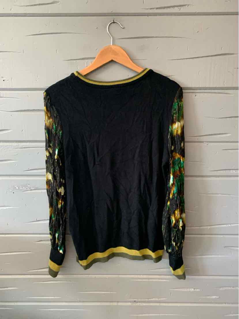 Black long-sleeve sweater with sheer floral print sleeves and yellow-green ribbed cuffs and collar.