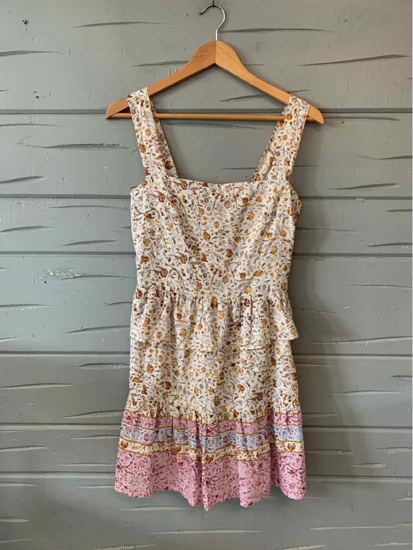 Sleeveless floral dress with gathered waist, square neckline, and pink patterned hem.