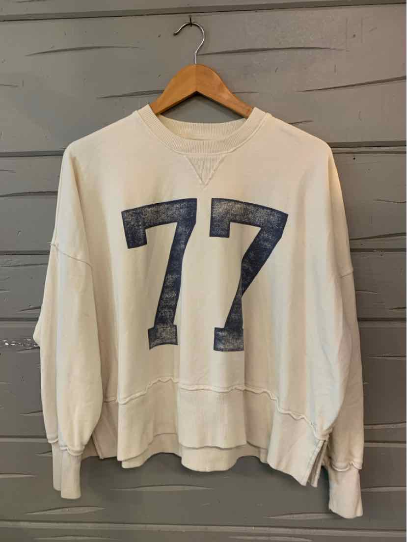 Cream-colored long-sleeve sweatshirt with navy distressed number 77 on front, crew neck, and ribbed cuffs and hem.