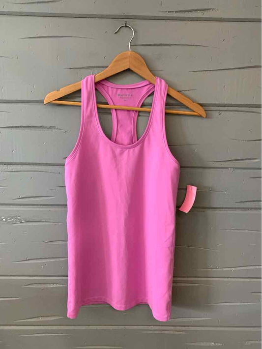 Pink sleeveless athletic tank top with racerback design hanging on wooden hanger.