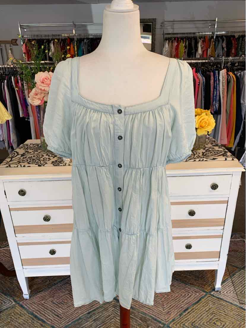 Light green tiered dress with square neckline and black buttons down front.
