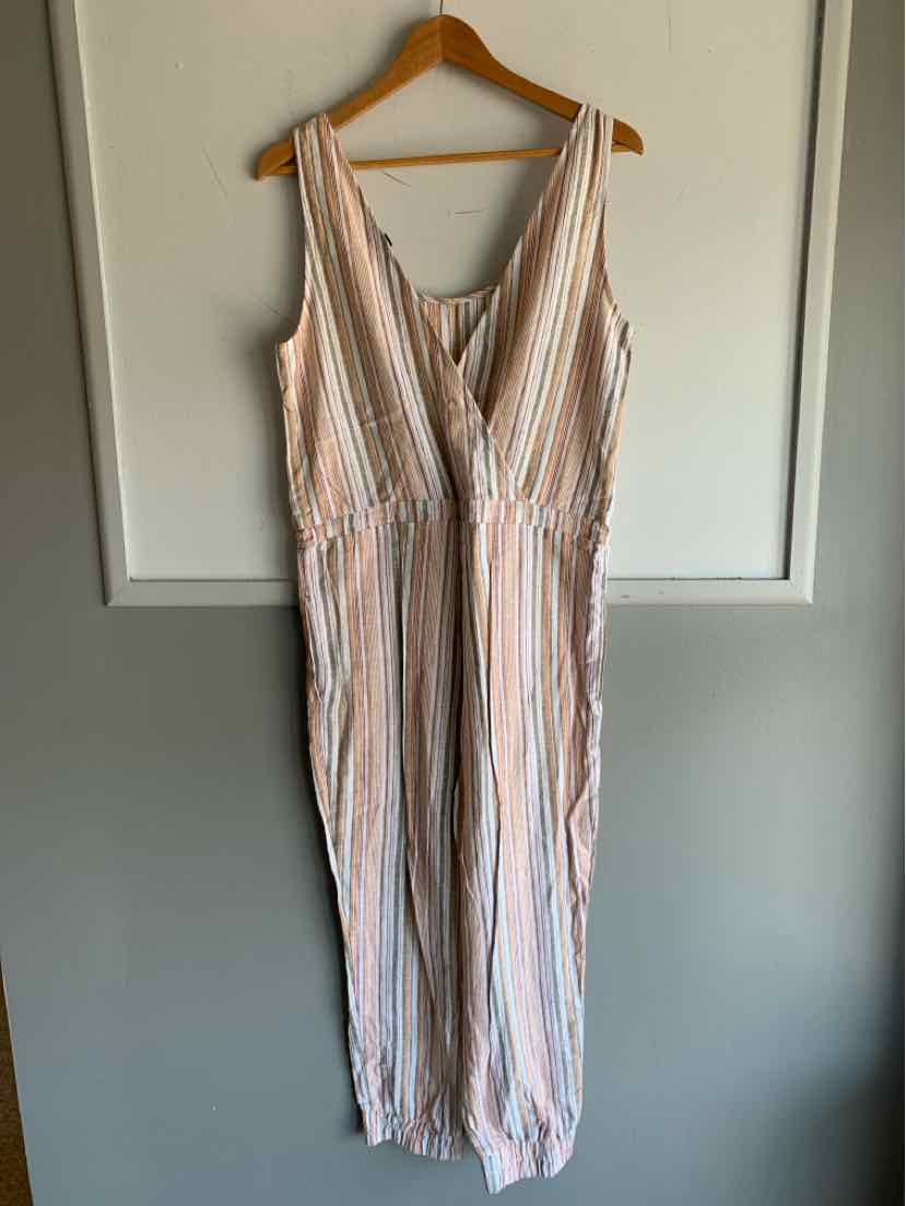 Orange and white striped sleeveless jumpsuit with V-neck and wide-leg pants on wooden hanger.