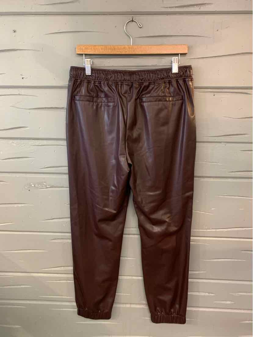 Burgundy faux leather jogger pants with elastic waistband and ankle cuffs.