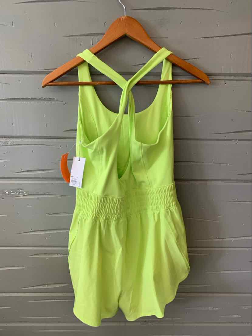 Neon yellow sleeveless romper with racerback straps and side pockets, lightweight fabric.