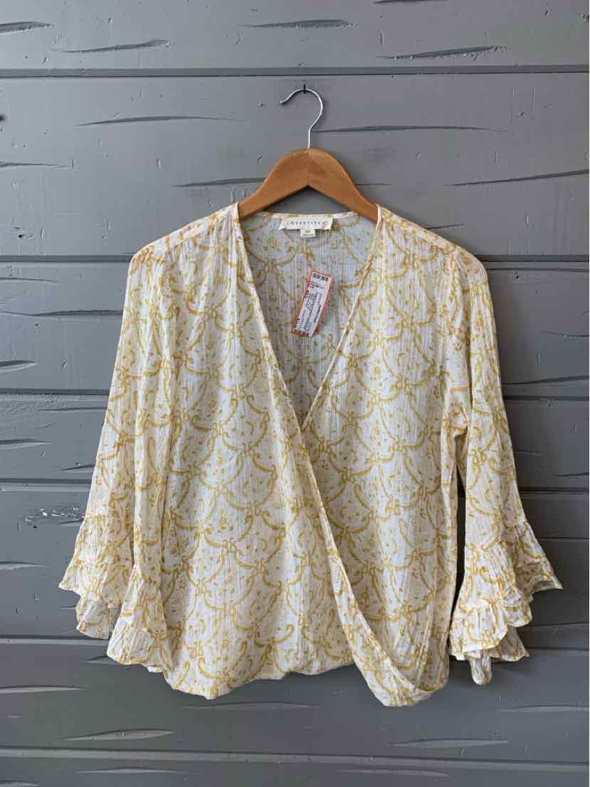 Cream blouse with yellow paisley print, V-neck crossover front, and ruffled bell sleeves.