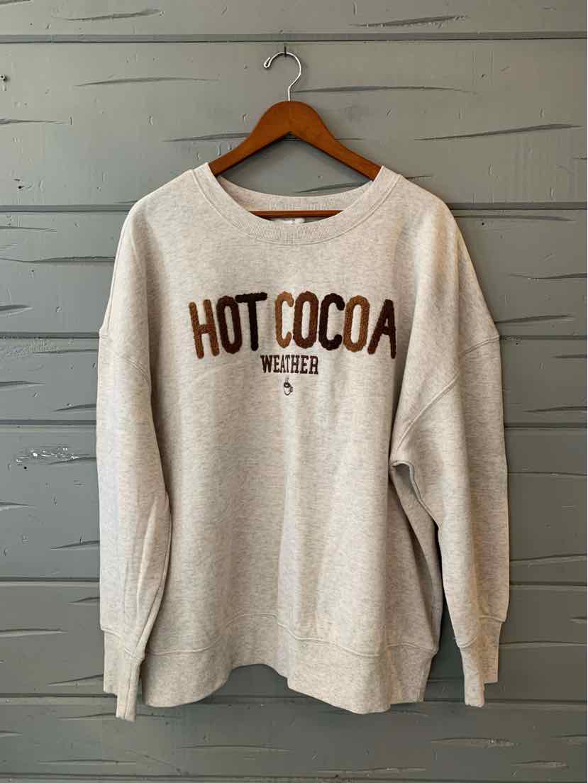 Women's beige long-sleeve top with bold “Hot Cocoa” lettering and a cozy relaxed fit.