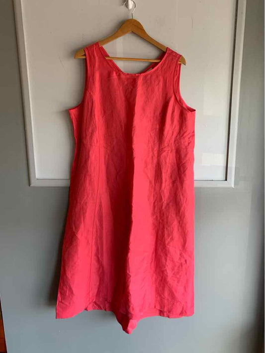 Sleeveless pink linen dress size XL with scoop neckline and relaxed fit hanging on wooden hanger.