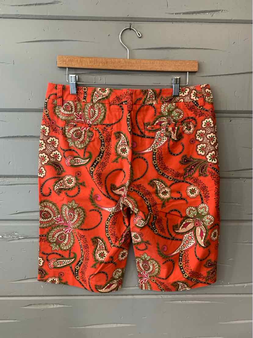 Orange paisley print cotton shorts with front pockets and belt loops, size 8.