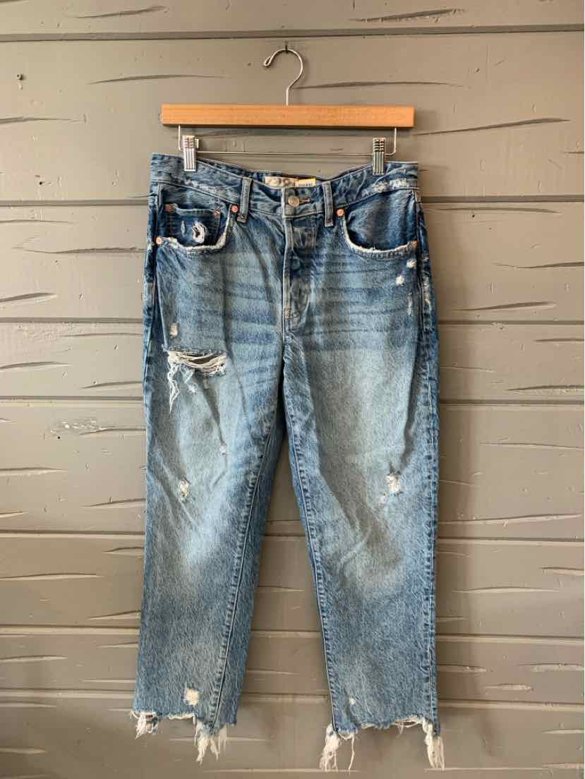 Light blue distressed denim jeans with ripped knees and frayed hems, size 6.