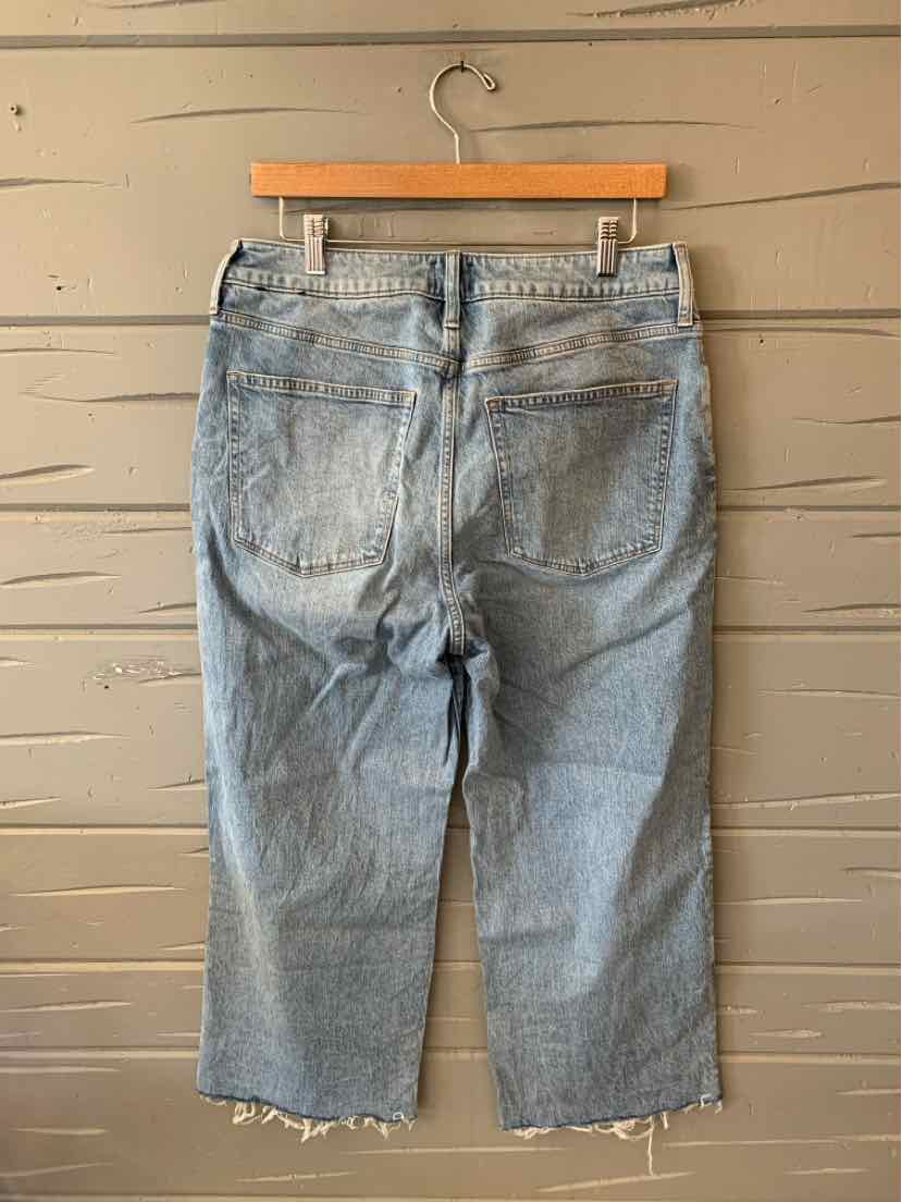 Light wash denim jeans with a straight leg and raw hem detailing at the cuffs.