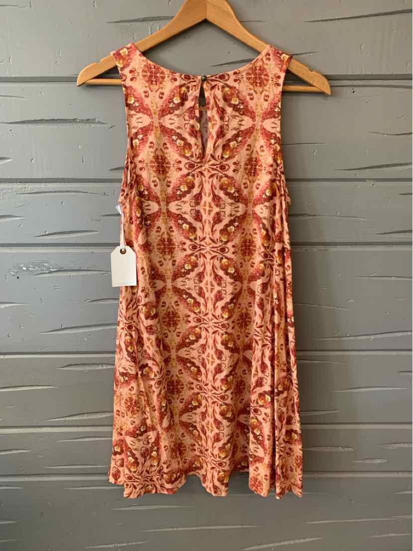 Sleeveless midi dress with rust and cream paisley print, lightweight fabric, round neckline, and A-line silhouette.