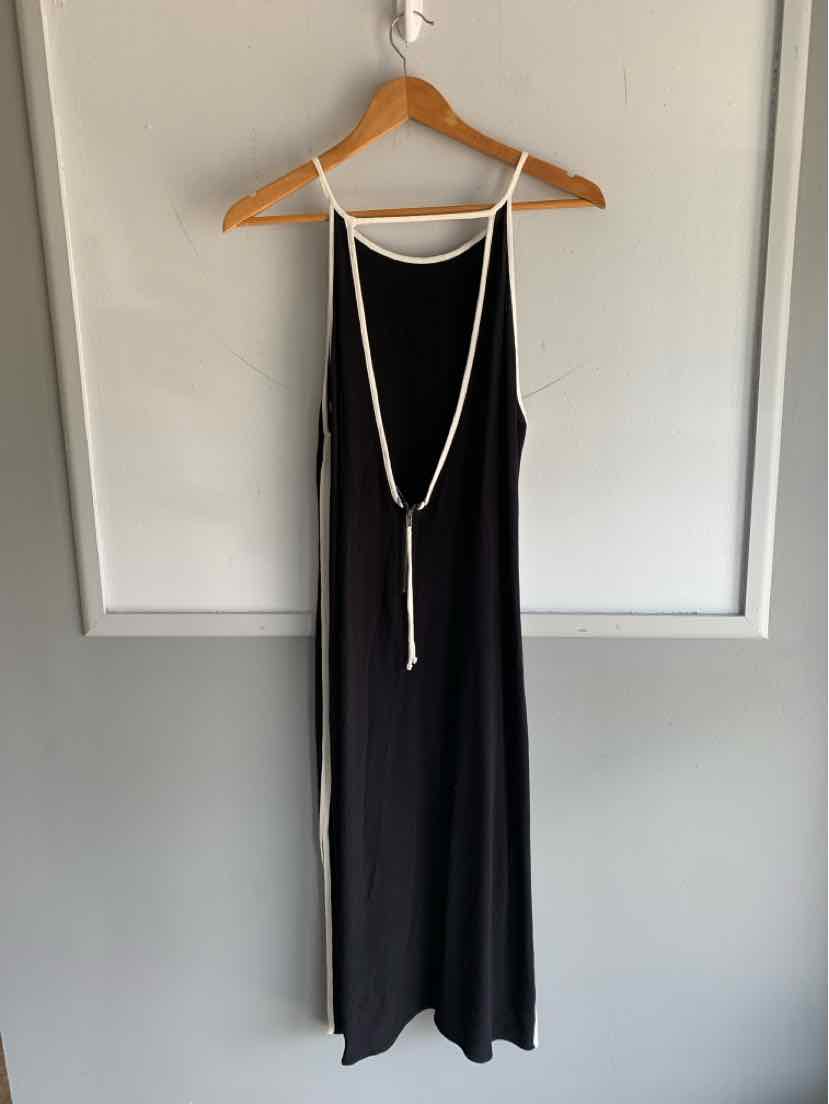 Black sleeveless maxi dress with thin straps and a white rope belt detail hanging at the front.