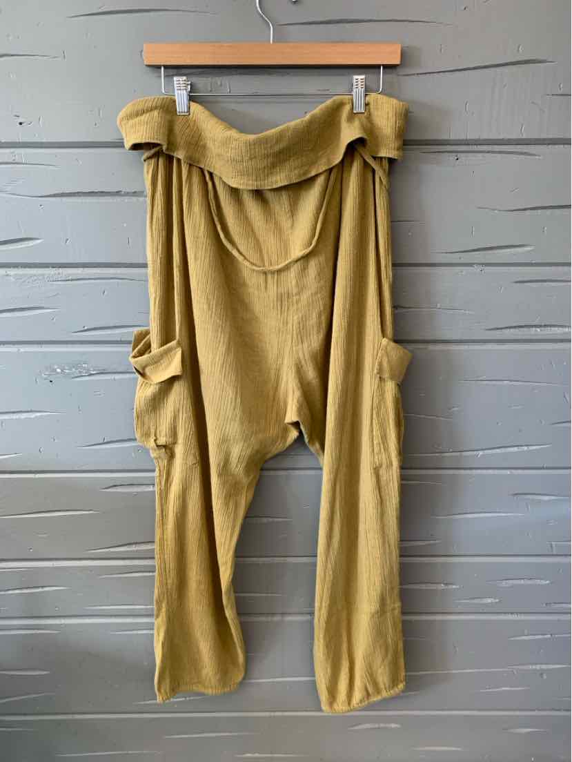 Mustard yellow wide-leg pants with dropped crotch and large side pockets, lightweight fabric.