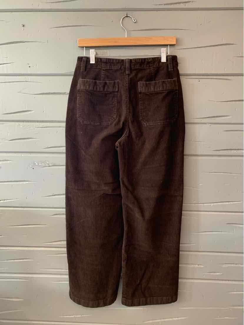 Dark brown straight-leg pants with back pockets and belt loops, hanging on wooden hanger.