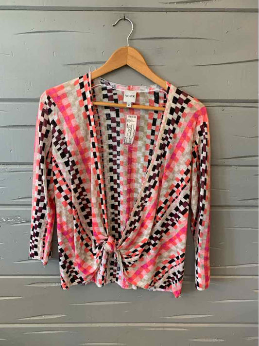 Womens cardigan with geometric pink, black, and white pattern, lightweight knit, front tie, and three-quarter sleeves.
