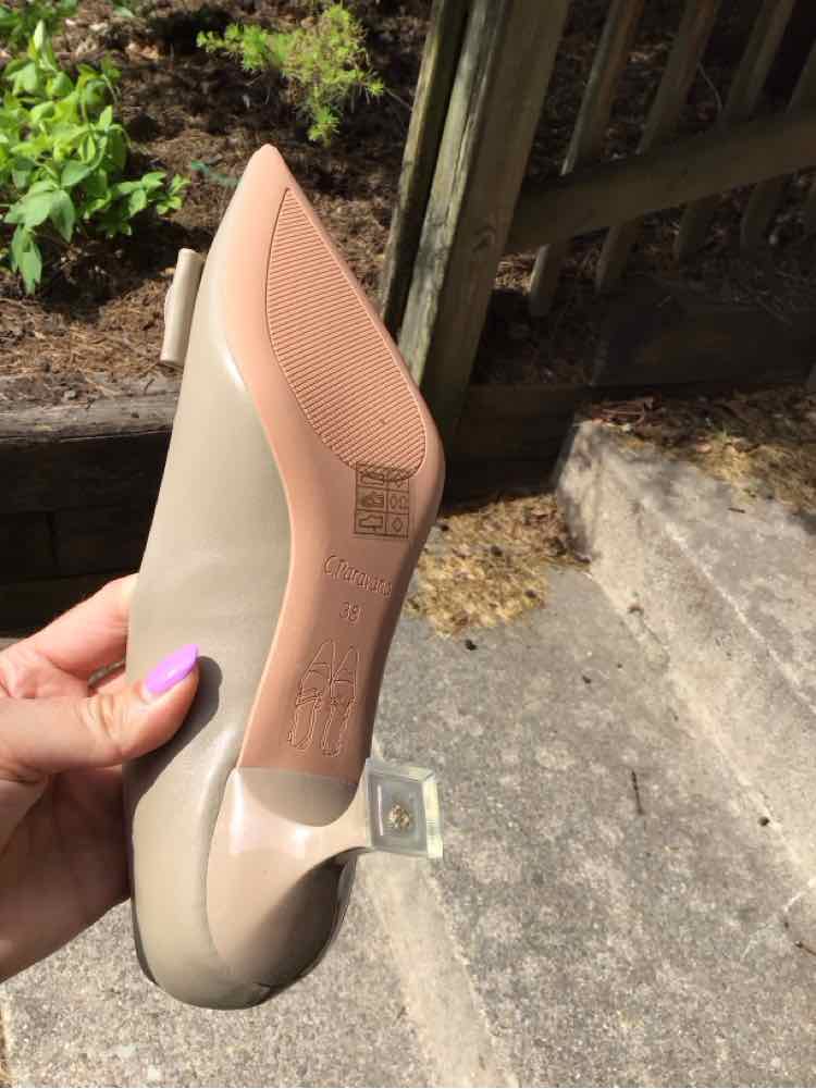Beige pointed-toe flat shoe with a clear square buckle detail on the back heel, size 38.