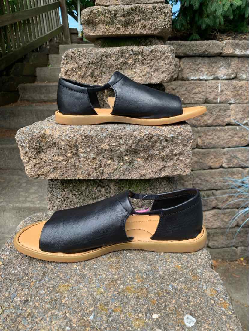 Black leather open-toe sandal with tan sole and low heel, size 9, slip-on design.