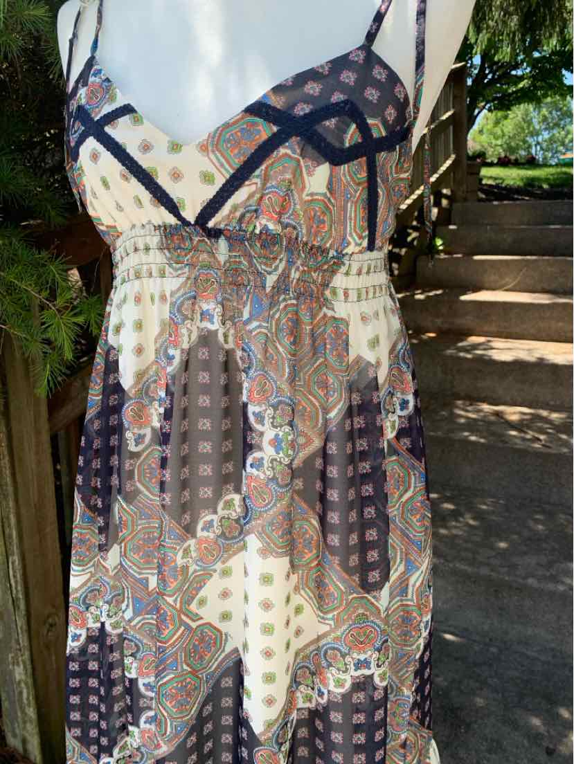 Sleeveless paisley-patterned maxi dress with adjustable straps and a V-neckline in earthy tones.