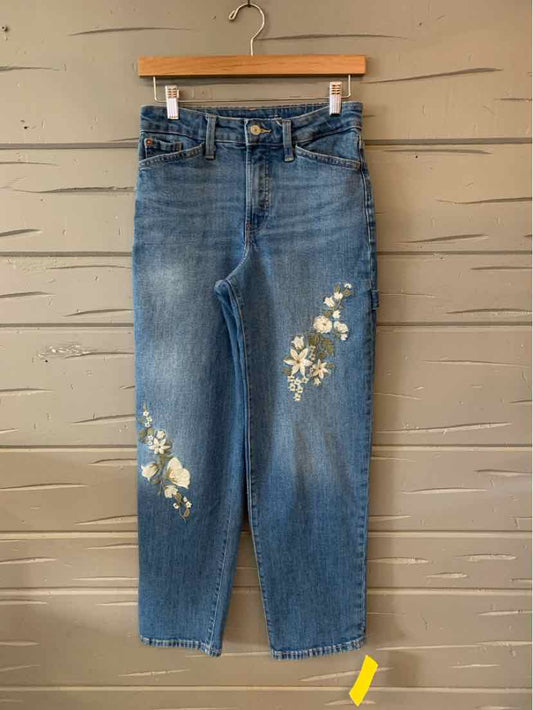 Blue high-waist straight-leg jeans with white floral embroidery on left thigh and right knee.