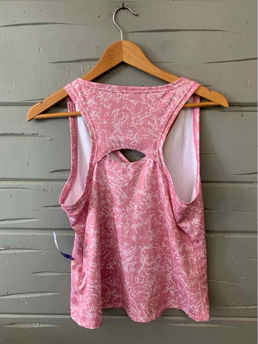 Pink patterned sleeveless crop top with keyhole cutout at back on wooden hanger.