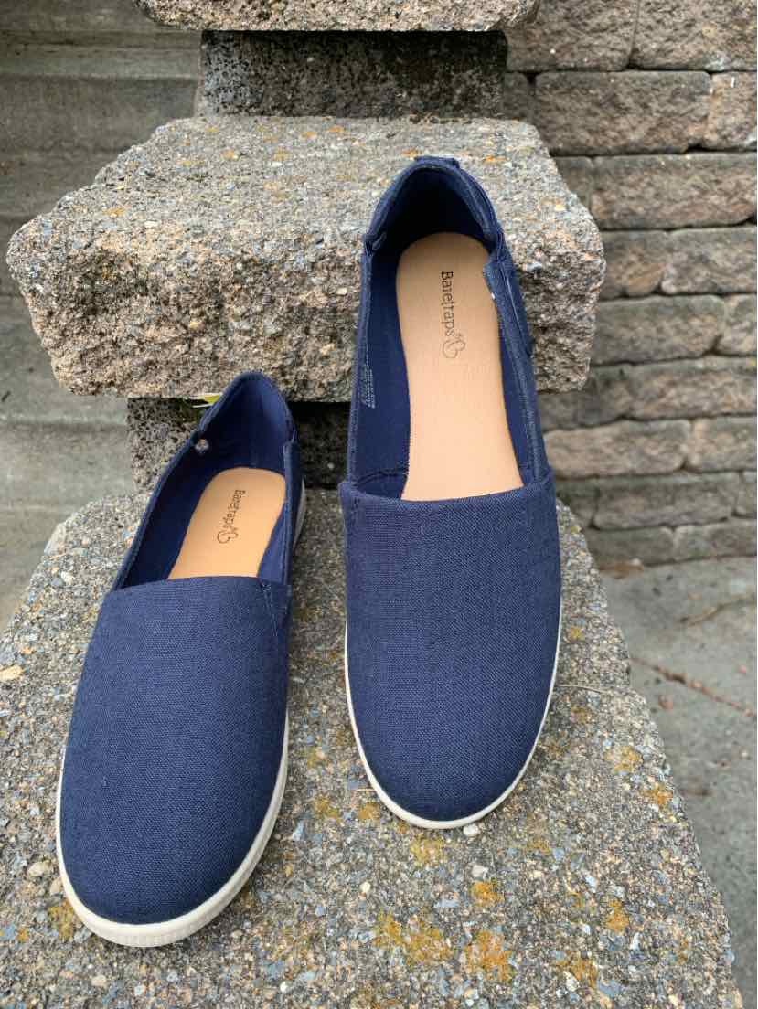 Navy blue slip-on casual shoes with white rubber soles and rounded toes.