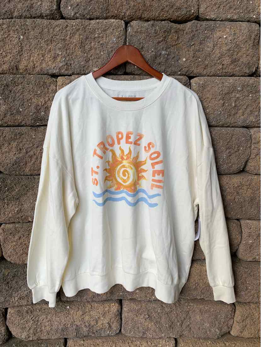 White long-sleeve crewneck sweatshirt with colorful St. Tropez Soleil graphic and sun design on front.