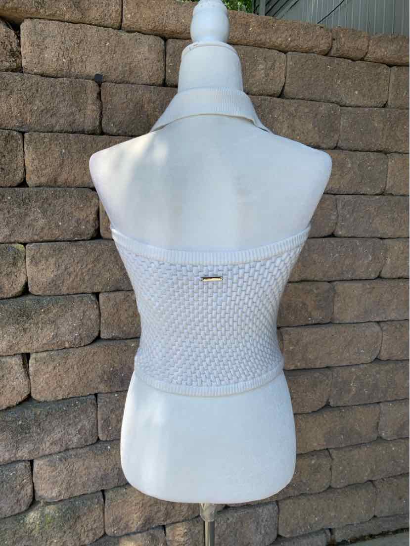 White knitted strapless tube top with textured stitch pattern and small metal logo tag at back center.