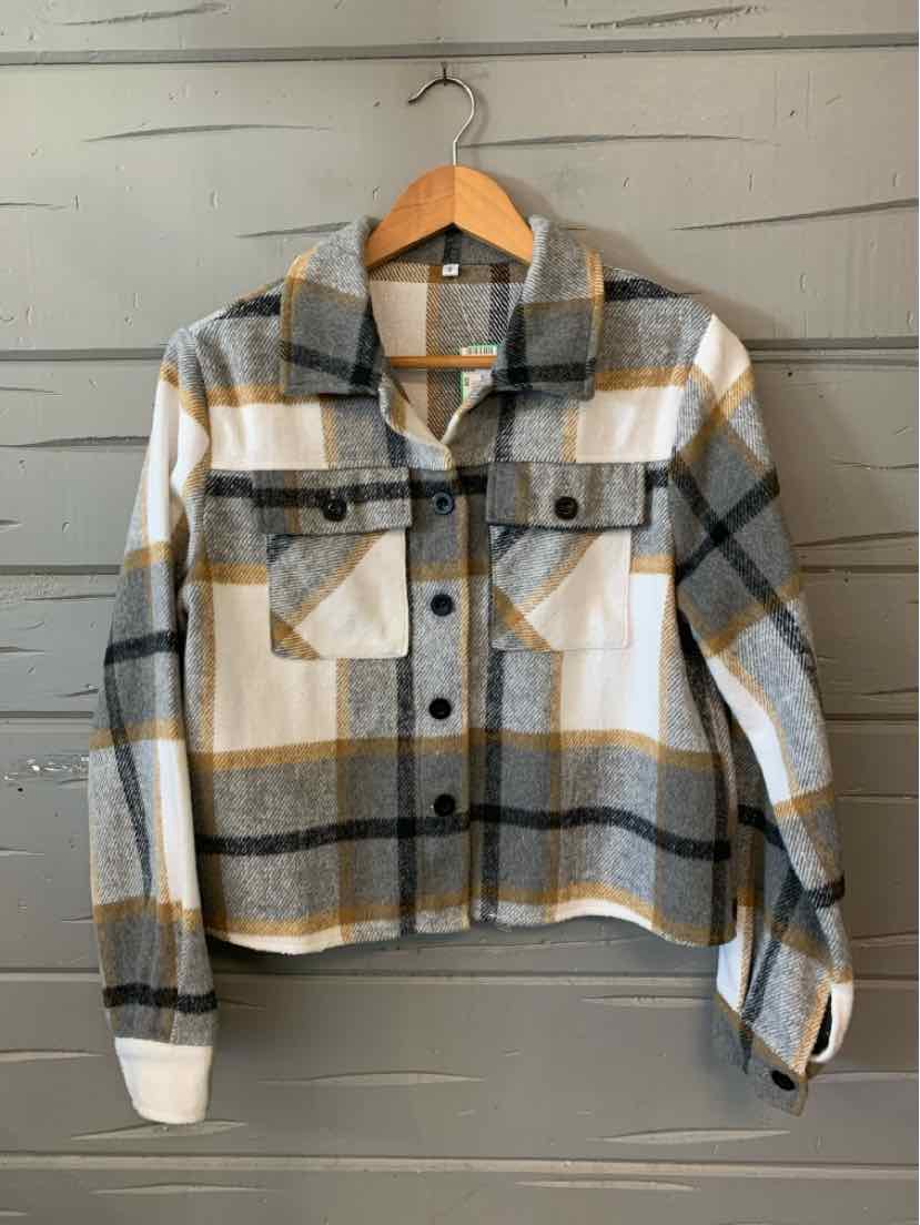 Gray, white, and beige plaid flannel jacket with button front and chest pockets on wooden hanger.