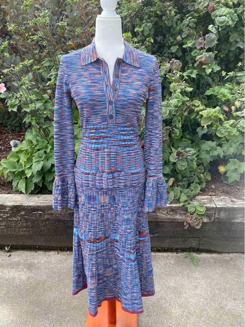Blue space-dyed knit two-piece dress with long sleeves, collar, and buttoned front.