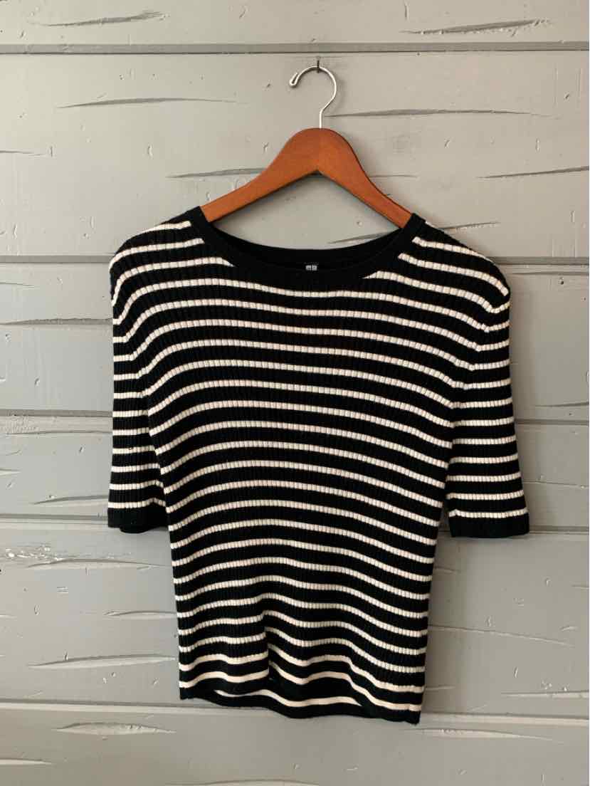Black and white striped short-sleeve knit top with a crew neckline, medium size hanging on wooden hanger.