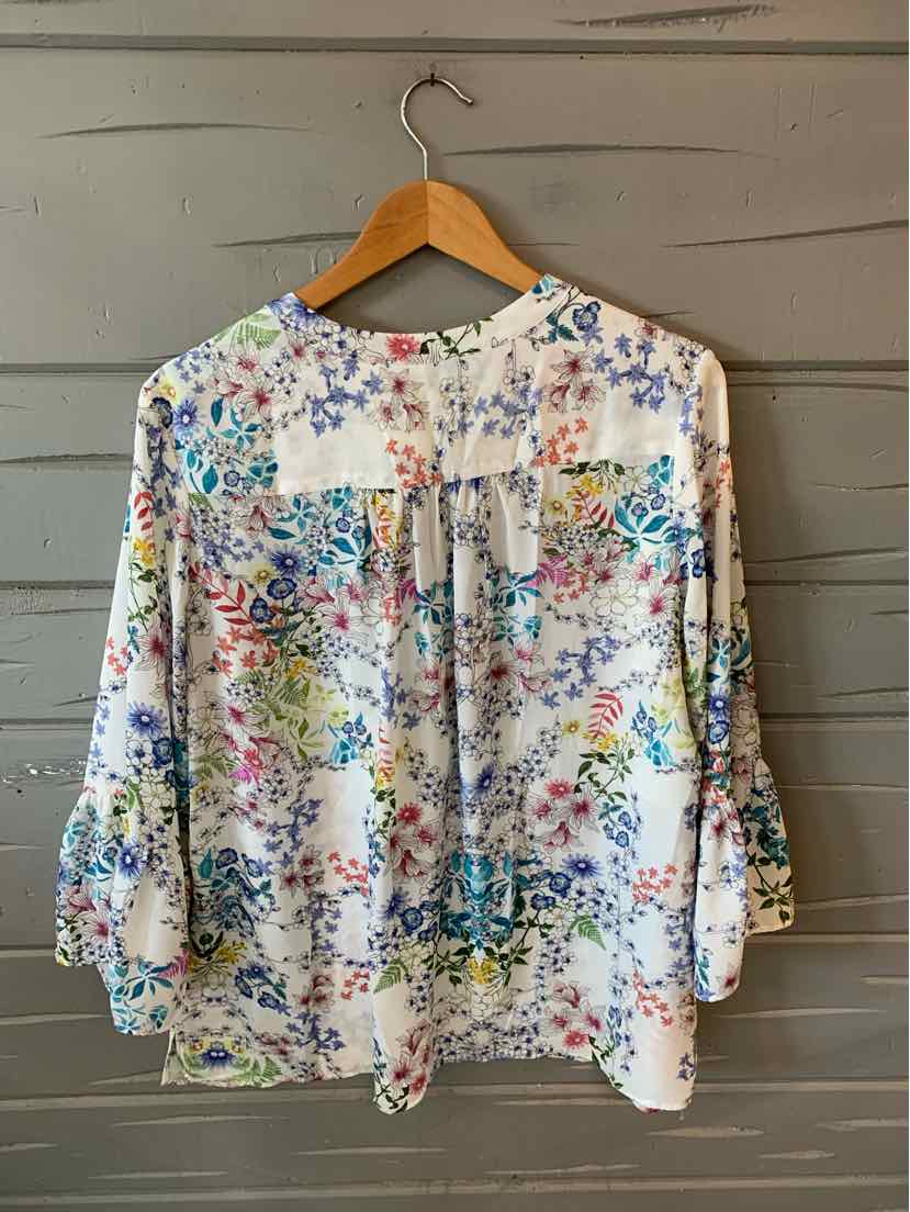 White floral blouse with violet, blue, and yellow flowers, 3/4 sleeves, and keyhole neckline.