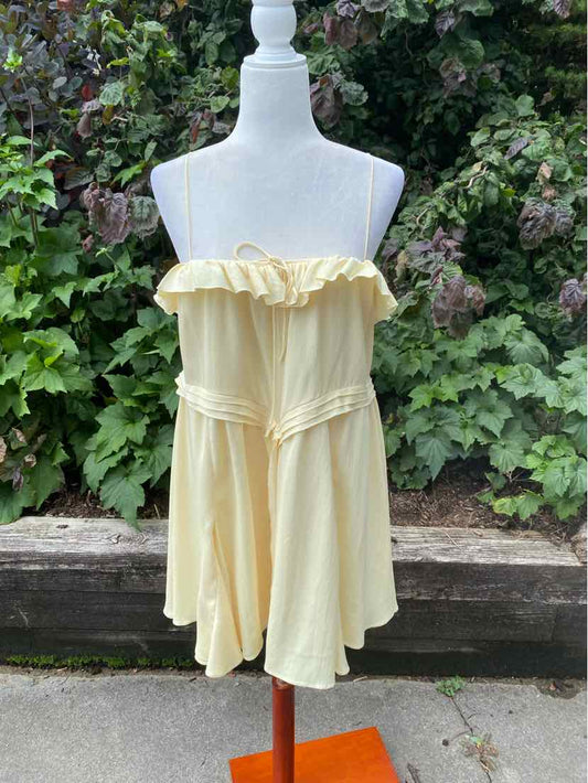 Light yellow strapless dress with ruffled neckline and flared skirt on white mannequin.