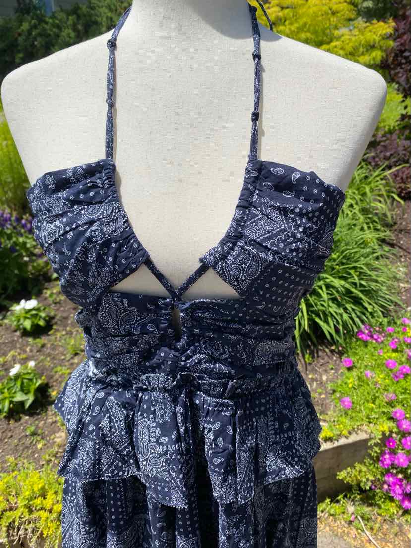Navy blue paisley halter dress with ruffled tiered skirt and tie front detail.