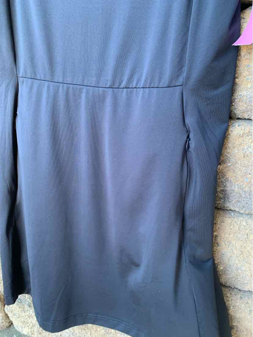 Black knee-length sports dress with short sleeves and side seam pockets, fitted waist design.