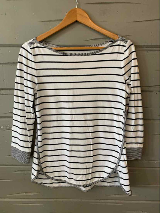 White long-sleeve shirt with thin black horizontal stripes and rounded neckline on wooden hanger.