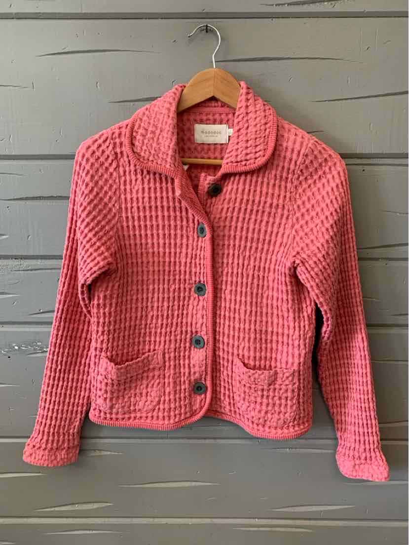 Pink waffle-knit button-up jacket with collar and front pockets on wooden hanger.