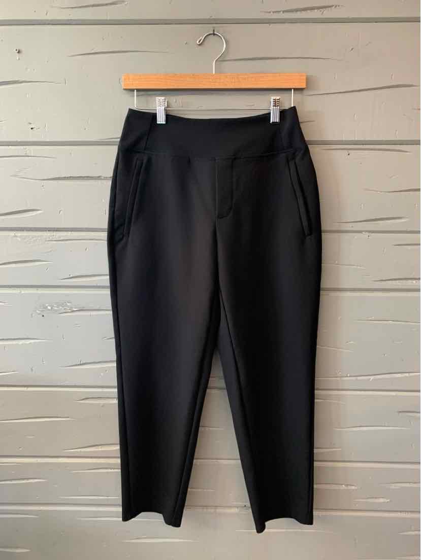 Black slim-fit pants with a slight stretch, elastic waistband, and side pockets.