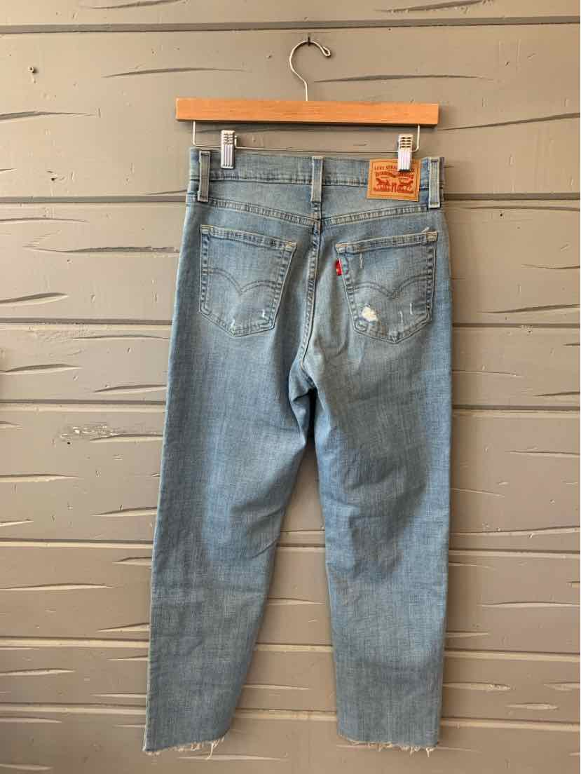 Light blue Levi's jeans size 28 with subtle distressing and leather brand patch on back waist.